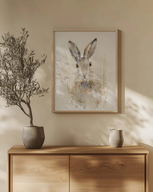 A lone hare with tall ears and steady eyes, painted in soft washes of earth and shadow. Watercolor original Sable by Chloe Duncan