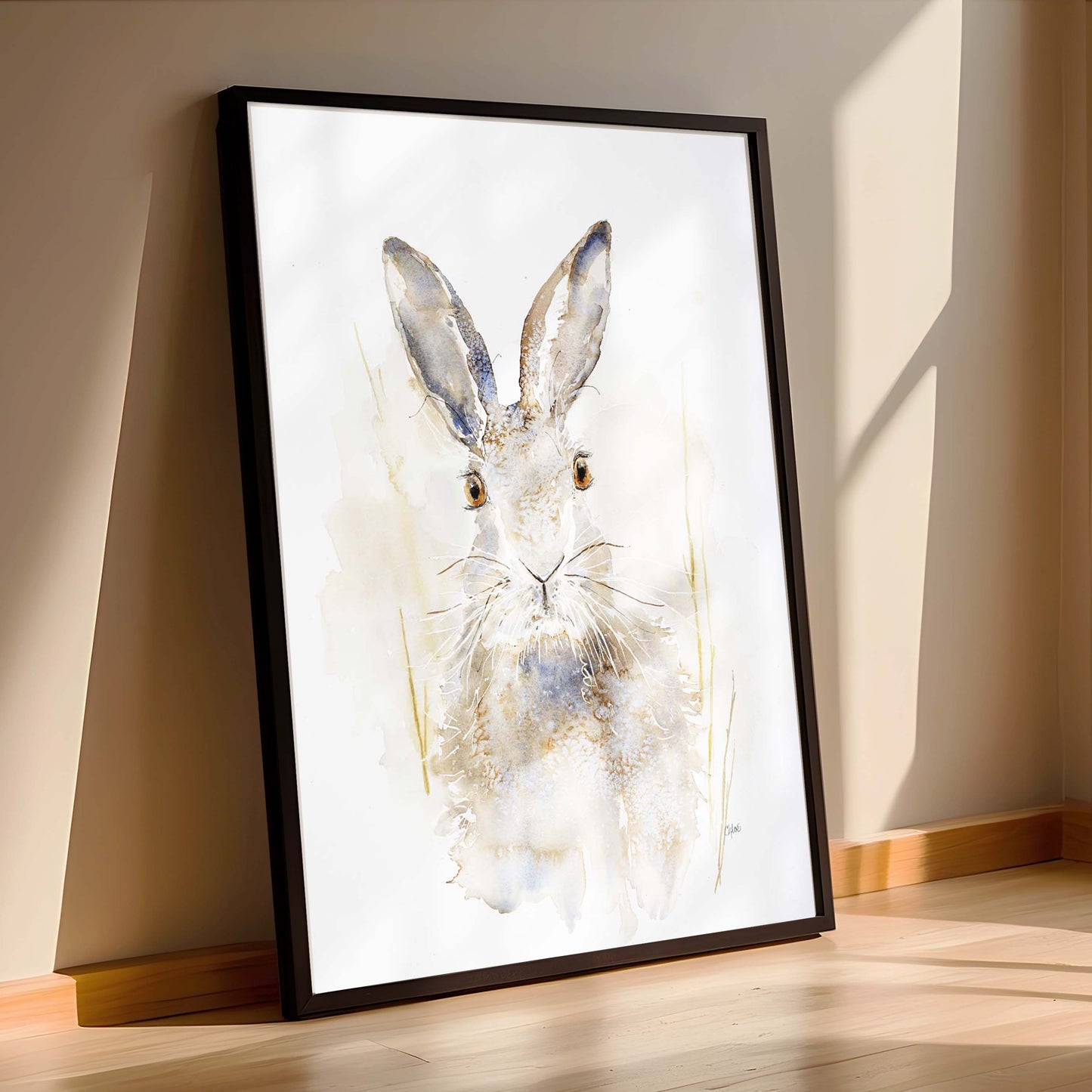 A lone hare with tall ears and steady eyes, painted in soft washes of earth and shadow. Watercolor original Sable by Chloe Duncan