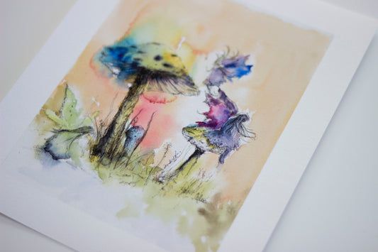 Watercolor painting of a single toadstool nestles in soft moss glowing faintly with a dreamlike light. A quiet, magical scene by Scottish artist Chloe Duncan, known for her gentle, folklore inspired nature at.