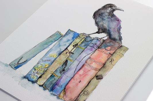 Watercolor painting of a cloaked crow perched uprighton top of old books, holding an old fashioned key in its claw. The background is a soft white, highlighting the dark silhouette and muted tones. Part of a dreamy folklore inspired series by Scottish artist Chloe Duncan