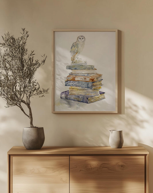 A barn owl rests atop a tower of worn Victorian books, painted in soft watercolor and original painting by Chloe Duncan"
